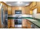 Kitchen featuring wooden cabinetry, stainless steel appliances, and solid surface counters at 806 Marcus Se St # 21, Atlanta, GA 30316