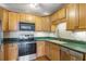 Bright kitchen featuring wooden cabinets, stainless steel appliances and light green countertop at 806 Marcus Se St # 21, Atlanta, GA 30316