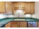 Wooden kitchen cabinets are accented by stainless steel appliances and green countertops at 806 Marcus Se St # 21, Atlanta, GA 30316
