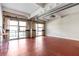 Living room featuring exposed ductwork, red floors, and large windows with decorative curtains at 806 Marcus Se St # 21, Atlanta, GA 30316