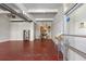 Bright living space boasts red floors, high ceilings, and an open layout connecting to the kitchen at 806 Marcus Se St # 21, Atlanta, GA 30316