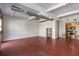 Spacious living area featuring red floors, exposed ductwork, and an open floor plan leading to the kitchen at 806 Marcus Se St # 21, Atlanta, GA 30316