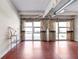 Spacious living room featuring polished floors, exposed ductwork, and large windows with natural light and neutral curtains at 806 Marcus Se St # 21, Atlanta, GA 30316