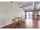 Bright living room with polished floors, exposed brick, and updated lighting fixtures, with bar table near bright windows at 806 Marcus Se St # 21, Atlanta, GA 30316
