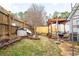 Spacious backyard with a wooden fence, a covered patio, and landscaping at 11 Montclair Ct, Cartersville, GA 30121