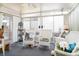 Enclosed sunroom featuring white wicker furniture and natural light from surrounding glass sliding doors at 11 Montclair Ct, Cartersville, GA 30121