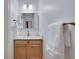 This powder room features a sleek vanity, gold fixtures, and modern lighting at 1865 Berkeley Mews Ne, Atlanta, GA 30329