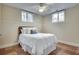 Cozy bedroom featuring a comfortable bed, warm tile floors, and natural light from two well-placed windows at 1865 Berkeley Mews Ne, Atlanta, GA 30329