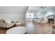 Bright bedroom featuring hardwood floors, a cozy chair, and large windows at 1865 Berkeley Mews Ne, Atlanta, GA 30329