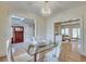 Bright dining room with hardwood floors, chandelier, and views to the living area at 1865 Berkeley Mews Ne, Atlanta, GA 30329