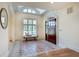 Bright foyer with a view of a large window, tiled flooring and a bench at 1865 Berkeley Mews Ne, Atlanta, GA 30329