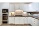 Modern kitchen featuring white cabinets, granite countertops, and stainless steel appliances at 1865 Berkeley Mews Ne, Atlanta, GA 30329