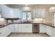 Classic kitchen featuring white cabinets, tile backsplash, and stainless steel appliances at 1865 Berkeley Mews Ne, Atlanta, GA 30329