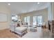 Cozy living room featuring hardwood floors, a stone fireplace, and access to the deck at 1865 Berkeley Mews Ne, Atlanta, GA 30329