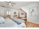 Bright main bedroom boasts white walls, hardwood floors, ceiling fan, and an ensuite bathroom at 1865 Berkeley Mews Ne, Atlanta, GA 30329