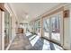 Long sun room featuring a tiled floor and multiple glass doors leading to the deck at 1865 Berkeley Mews Ne, Atlanta, GA 30329