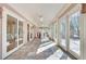 Sun room featuring a tiled floor and multiple glass doors leading to the deck at 1865 Berkeley Mews Ne, Atlanta, GA 30329