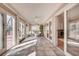 Bright sun room with tiled floor and multiple glass doors at 1865 Berkeley Mews Ne, Atlanta, GA 30329