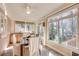 Well-lit sun room with a dining area and a large window overlooking the yard at 1865 Berkeley Mews Ne, Atlanta, GA 30329