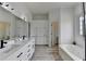 Bright bathroom featuring double sinks, cabinets, and a soaking tub for a comfortable and clean space at 2860 Chardonnay Ln, Cumming, GA 30041