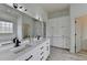 Beautiful bathroom featuring double sinks, cabinets, and a window for natural light at 2860 Chardonnay Ln, Cumming, GA 30041