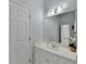 Bright bathroom featuring a modern vanity with gold fixtures, contemporary lighting, and a large mirror at 2860 Chardonnay Ln, Cumming, GA 30041