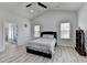 Bright bedroom features wood floors, a ceiling fan, and a view into the luxurious bathroom with glass shower at 2860 Chardonnay Ln, Cumming, GA 30041