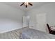 Bright bedroom featuring wood-look floors, a ceiling fan, and double closets at 2860 Chardonnay Ln, Cumming, GA 30041