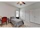 Well-lit bedroom featuring wood-look floors, a ceiling fan, a single bed, and double closets at 2860 Chardonnay Ln, Cumming, GA 30041