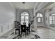 Elegant dining room featuring modern chandelier, wainscoting, and large arched window at 2860 Chardonnay Ln, Cumming, GA 30041