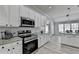 Kitchen features stainless steel appliances, white cabinets, granite countertops and hardwood flooring at 2860 Chardonnay Ln, Cumming, GA 30041