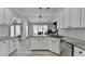 This kitchen features gray countertops, white cabinets, hardwood flooring, and lots of light at 2860 Chardonnay Ln, Cumming, GA 30041