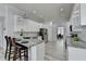 Kitchen with white cabinets, granite countertops, an island with bar seating, and stainless steel appliances at 2860 Chardonnay Ln, Cumming, GA 30041