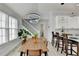 The kitchen features a dining area, stairs, natural light, and hardwood flooring at 2860 Chardonnay Ln, Cumming, GA 30041