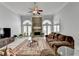 Bright living room with stone fireplace, ceiling fan, hardwood floors, and lots of natural light at 2860 Chardonnay Ln, Cumming, GA 30041