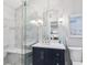 Stylish bathroom with glass shower, marble tiles, and navy vanity at 3154 Chamblee Tucker Rd, Atlanta, GA 30341