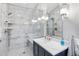 Bathroom featuring a glass shower with white marble tiling, a white countertop, and modern lighting at 3154 Chamblee Tucker Rd, Atlanta, GA 30341