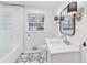 Charming bathroom features shiplap walls, patterned tile, and a vanity with marble countertop at 3154 Chamblee Tucker Rd, Atlanta, GA 30341