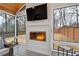 Elegant fireplace with mounted TV in a sunroom featuring lots of natural light and views of the outdoors at 3154 Chamblee Tucker Rd, Atlanta, GA 30341