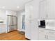 Bright kitchen with stainless steel appliances, white cabinets, and hardwood floors at 3154 Chamblee Tucker Rd, Atlanta, GA 30341