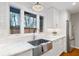 Bright kitchen featuring a farmhouse sink, white cabinets, and natural light at 3154 Chamblee Tucker Rd, Atlanta, GA 30341