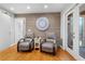 Relaxing sitting area with wood accent wall, cozy chairs, and access to outdoor porch at 3154 Chamblee Tucker Rd, Atlanta, GA 30341