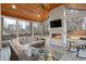 Bright sunroom with a vaulted wooden ceiling, a contemporary fireplace, and plenty of seating for relaxation and entertainment at 3154 Chamblee Tucker Rd, Atlanta, GA 30341