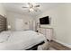 Cozy bedroom with neutral walls, a ceiling fan, and a comfortable bed with cushioned headboard at 6124 Locklear Way, Douglasville, GA 30134