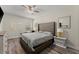 This main bedroom features hard wood floors, a ceiling fan and a tufted headboard at 6124 Locklear Way, Douglasville, GA 30134