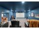 Dark movie room features theater seating, a large projector screen, and fun movie decorations at 6124 Locklear Way, Douglasville, GA 30134