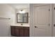 Bathroom with a vanity, framed mirror, and door to a shower at 6515 Bentley Ridge Dr, Cumming, GA 30040