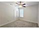 Neutral bedroom featuring a ceiling fan, window with blinds, and plush carpeting for comfort at 6515 Bentley Ridge Dr, Cumming, GA 30040