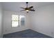 Bedroom with plush carpet, a window, and a ceiling fan at 6515 Bentley Ridge Dr, Cumming, GA 30040