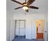 Bright bedroom featuring a ceiling fan and a closet with custom shelving and storage at 6515 Bentley Ridge Dr, Cumming, GA 30040